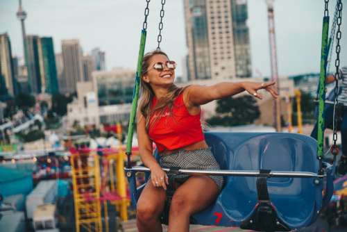 Young Woman Smiling On Swing Ride Photo