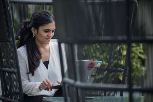 Young Woman Working On Her Laptop Outside Photo