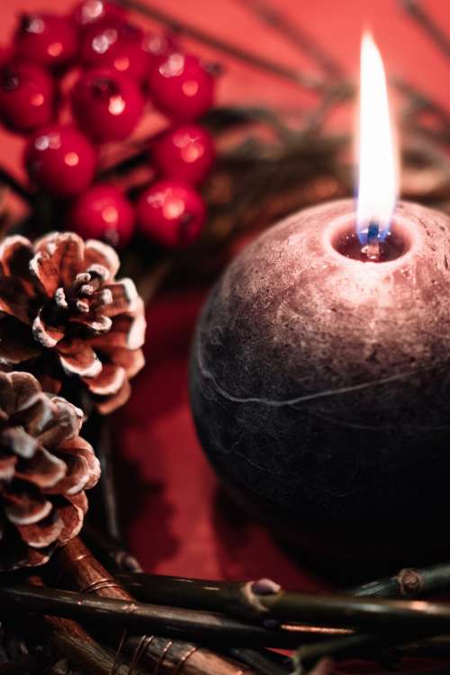 Christmas wreath and a round candle closeup