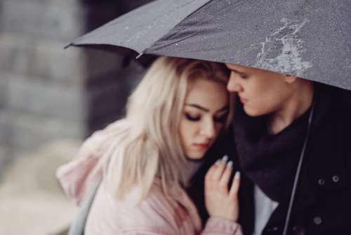 Couple hugging under an umbrella 2