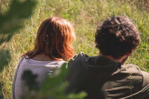 Couple sitting in the meadow 2