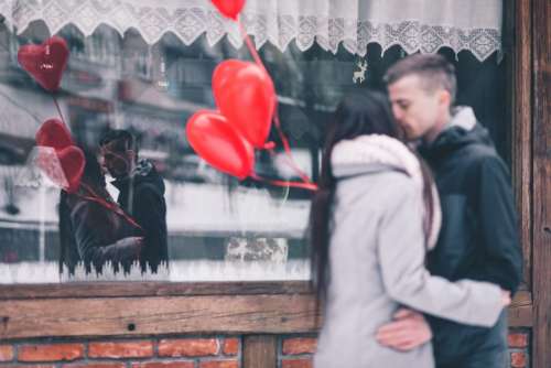 A couple with heart shape baloons
