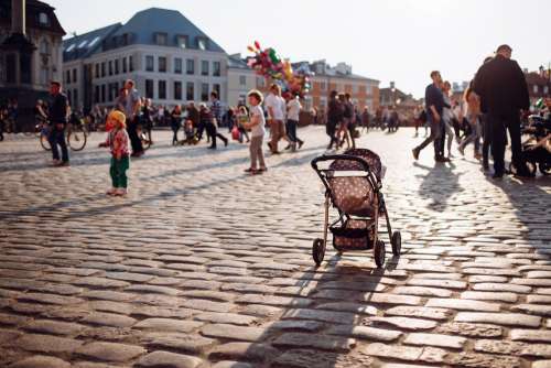 An empty stroller in a crowded Old Town square 3