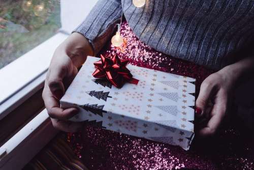 A female holding a christmas gift