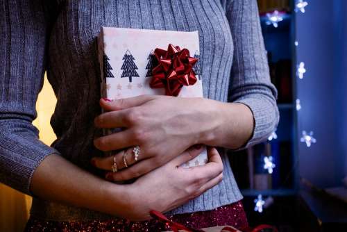 A female holding a christmas gift 5