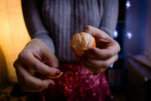A female peeling a mandarin