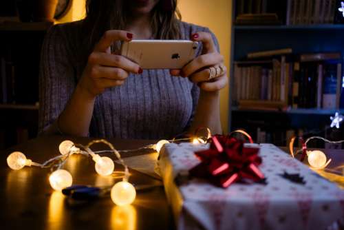 A female taking picture of a christmas gift