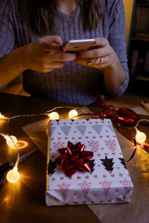 A female taking picture of a christmas gift 2