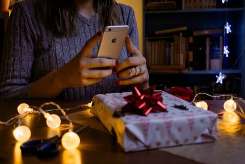 A female taking picture of a christmas gift 3