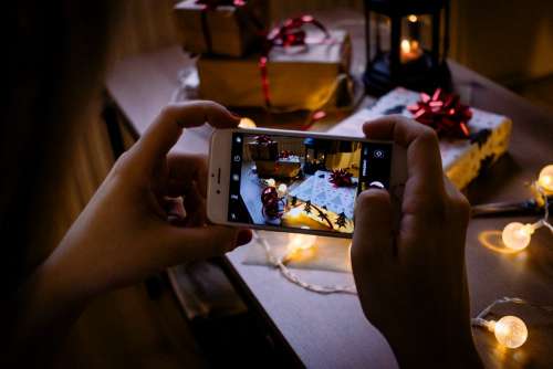 A female taking picture of a christmas gift 5