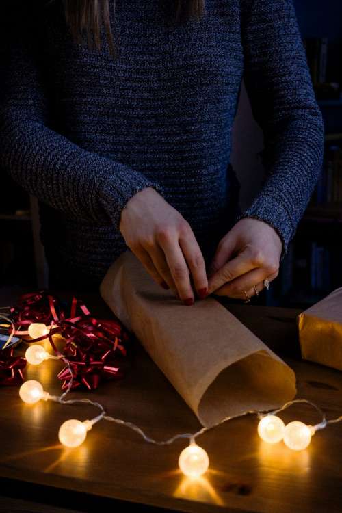 A female wrapping a gift