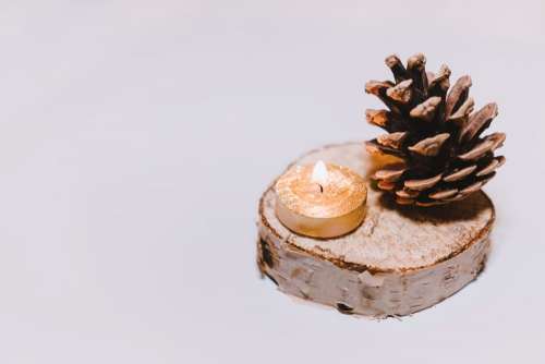 Gold tealight and a pinecone