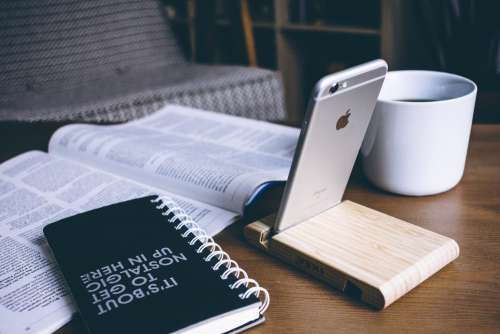 iPhone in a wooden phone holder 4