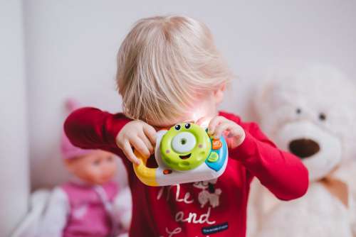 Little girl with a toy camera