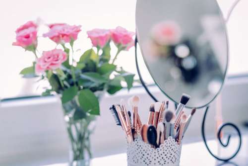Makeup brushes and roses