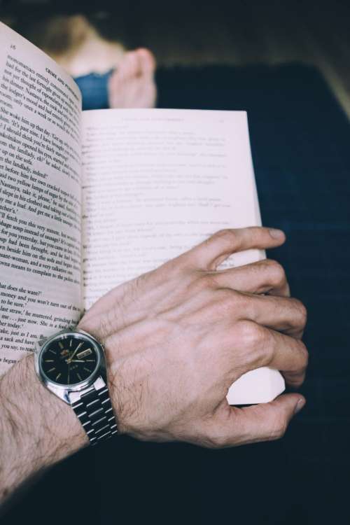 Male hand holding an open book 2