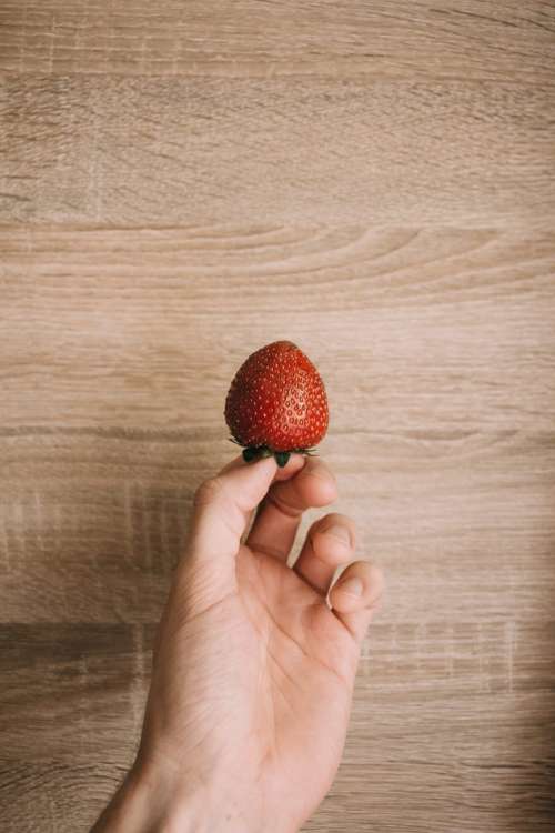 Strawberry in a male hand 2