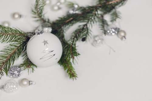 White and silver baubles with a spruce twig