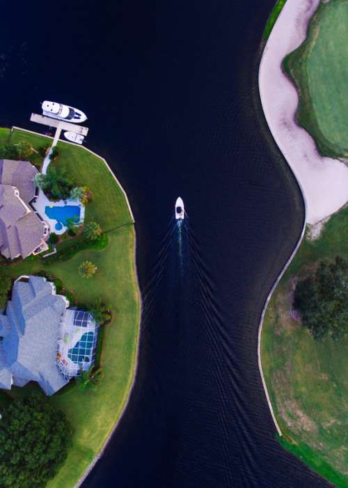 House and boat in Canal in Florida free photo