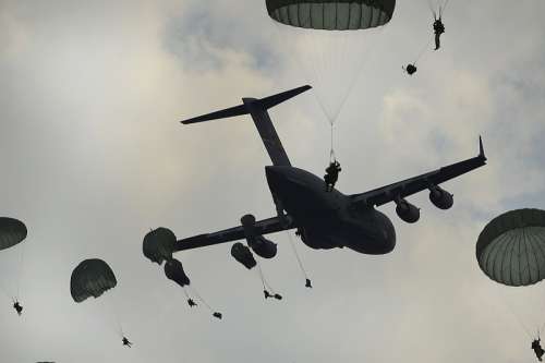 Airborne Paratroopers being dropped from a C-17 free photo