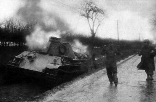 American Soldier escorting German  Crewman from burning Panther Tank during the Battle of the Bulge free photo