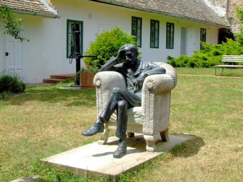 Babits Memorial House with man sitting in chair in Szekszárd, Hungary free photo