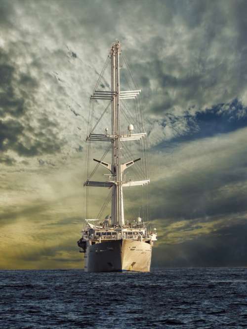 Battleship under the skies and clouds sailing free photo