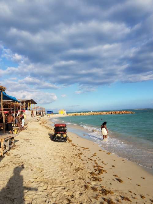Beach and Shacks by the ocean under the skies in Kingston, Jamaica free photo