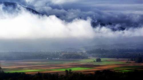 Beautiful Farm and Forest Landscape under the clouds in the French Alps free photo