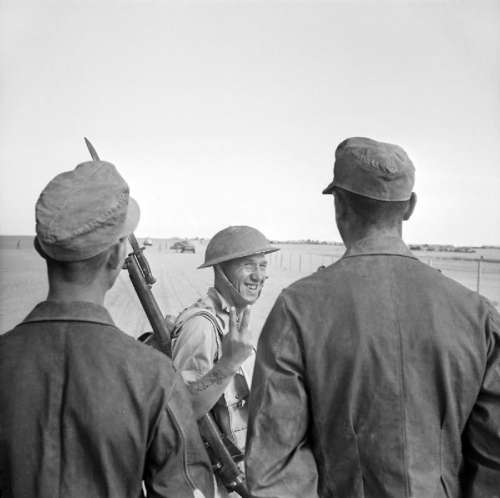 British soldier gives a V gesture to German prisoners during Second battle of El Alamein free photo