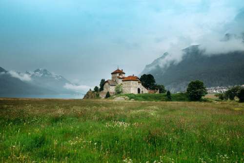 Castle on the end of a grassy field in Saint Moritz, Switzerland free photo