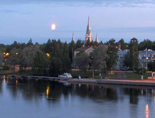  Church of Joensuu on the riverbank under the midnight sun in Finland free photo