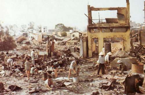 Civilians sort through the ruins of their homes in Cholon in the Vietnam War free photo