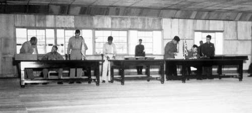 Delegates sign the Korean Armistice Agreement in P'anmunjŏm free photo