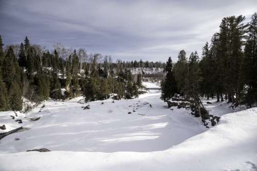 Frozen Gooseberry River landscape covered in Snow at Gooseberry Falls State Park, Minnesota free photo