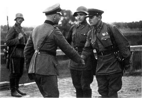 German and Soviet army officers pictured shaking hands After the division of Poland, World War II free photo