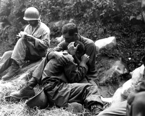 G.I. comforting a grieving infantryman in Korean War free photo