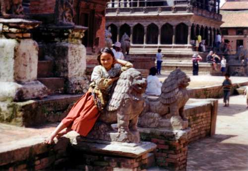 Girl Leaning on a statue in Kathmandu, Nepal free photo