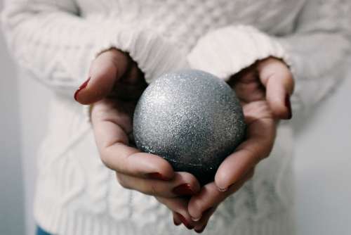 Hands holding a Christmas Ornament Ball  free photo