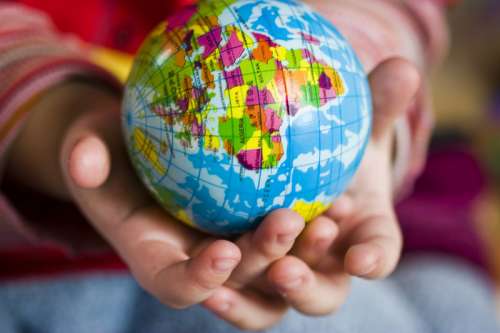 Hands holding small globe of earth free photo