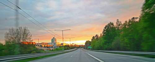 Highway and road into the sunset in town free photo