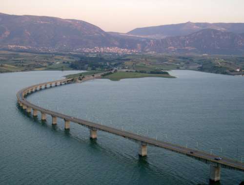 Lake Polyfytos Bridge crossing the lake landscape in Kozani, Greece free photo