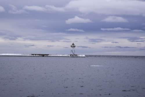 Lighthouse under the cloudy skies in Grand Marais, Minnesota free photo