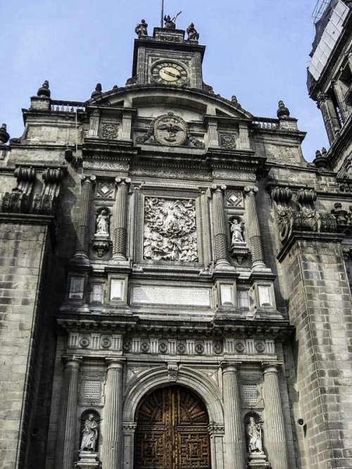 Main portal with view of clock at the Mexico City Cathedral free photo