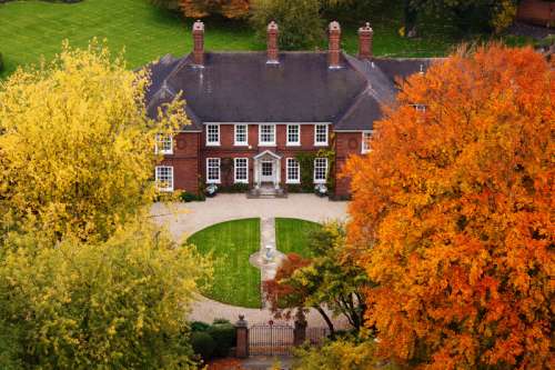 Mansion with autumn trees free photo