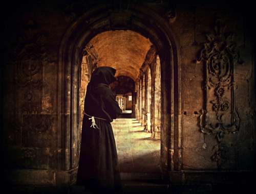 Monk standing in the doorway of a Monastery free photo