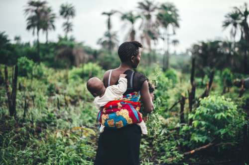 Mother Carrying Baby on Back in Sierra Leone free photo