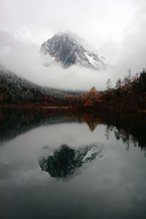 Mountain and Reflection with clouds and Mist in the water in Sichuan, China free photo