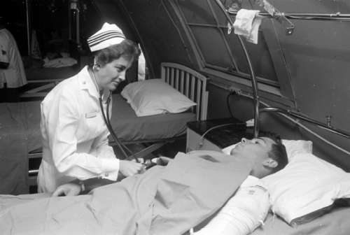 Nurse Treating Soldier in Hospital during the Vietnam War free photo