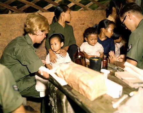 Nurse treats a Vietnamese child, 1967 during the Vietnam War free photo